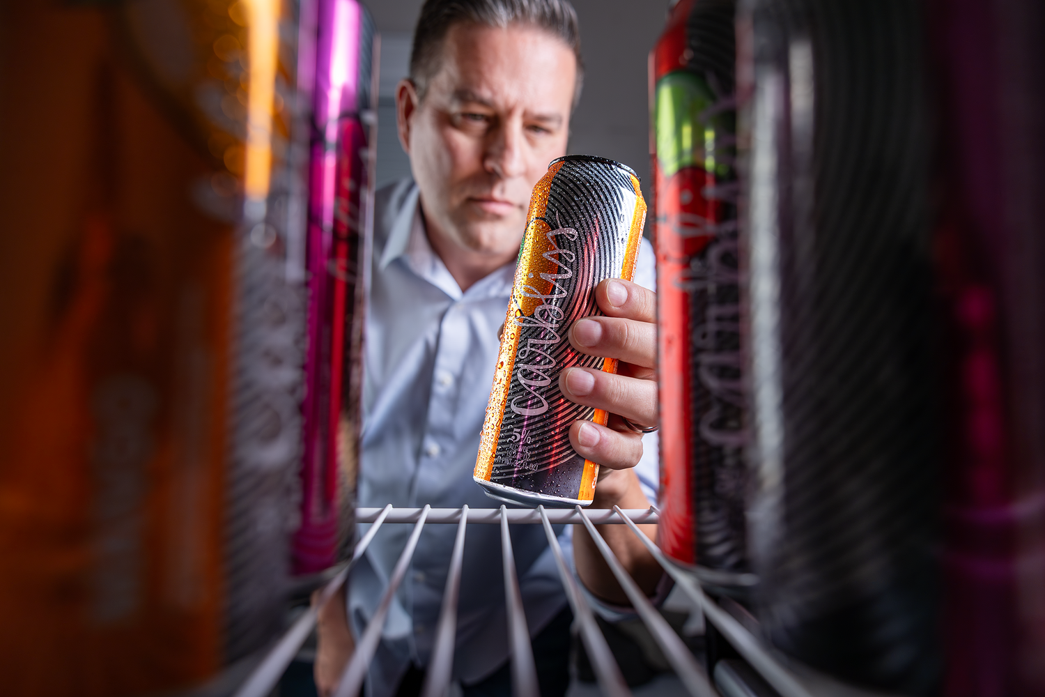 Man grabbing a Carbliss Cocktails Mango out of the refrigerator